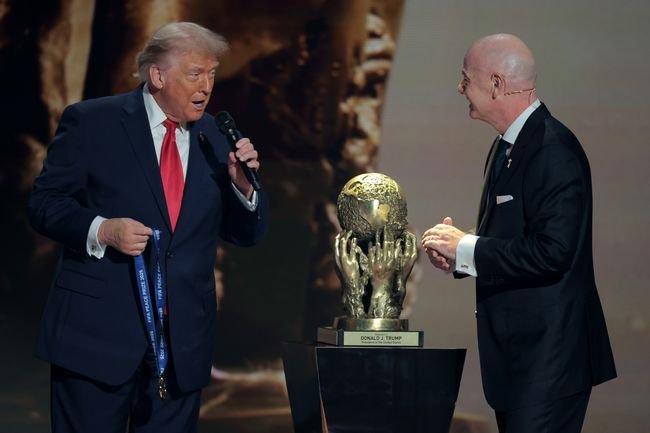 Donald Trumps bizarre hidden signal as fanboy FIFA president hands him peace prize Donald Trumps bizarre hidden signal as fanboy FIFA president hands him peace prize